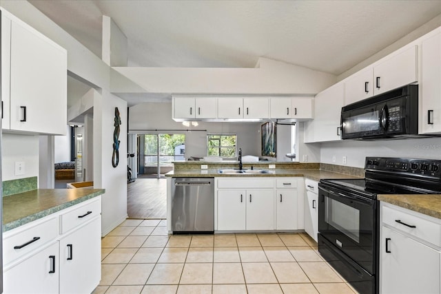 kitchen with light tile patterned floors, lofted ceiling, a peninsula, black appliances, and a sink