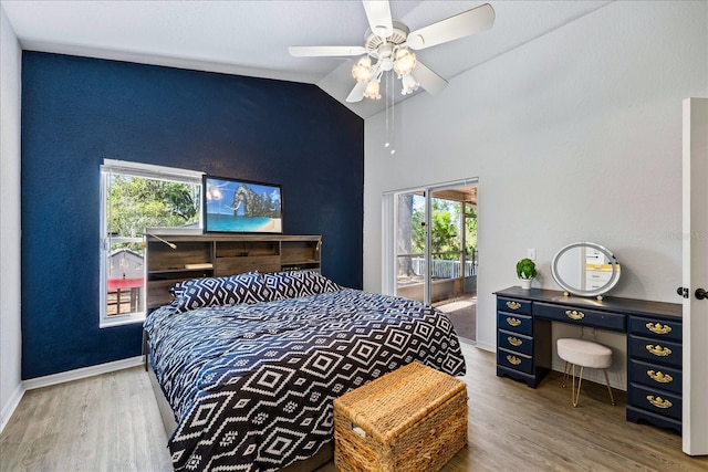 bedroom with ceiling fan, baseboards, vaulted ceiling, and wood finished floors