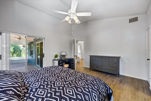 bedroom with baseboards, access to outside, visible vents, and wood finished floors