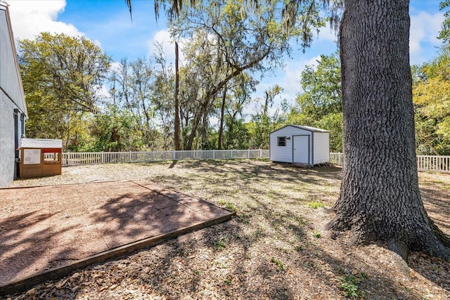 view of yard featuring an outbuilding, a shed, and a fenced backyard