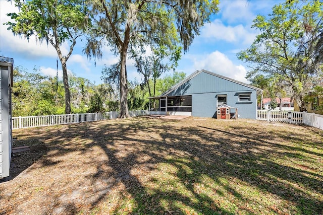 back of house with a sunroom and a fenced backyard