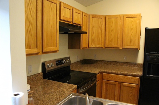 kitchen with stainless steel electric stove, lofted ceiling, dark countertops, black fridge with ice dispenser, and under cabinet range hood