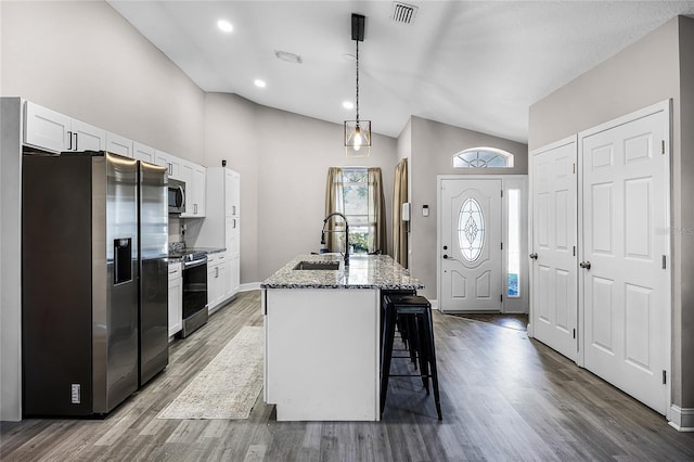 kitchen featuring a sink, stainless steel appliances, light stone countertops, and white cabinetry