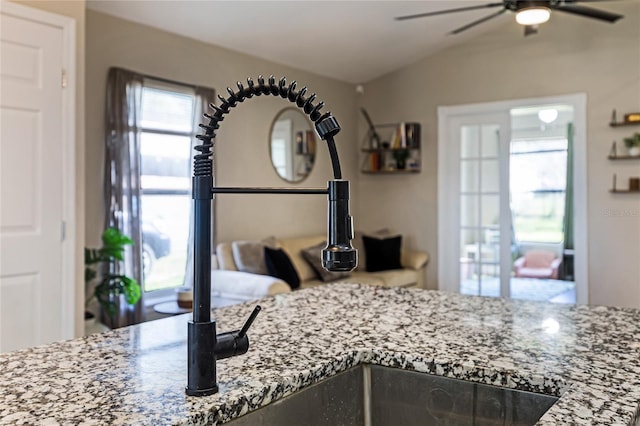 room details featuring stone counters and a ceiling fan