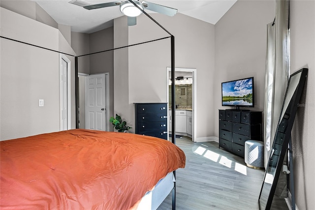 bedroom featuring light wood-style floors, baseboards, ensuite bathroom, and ceiling fan