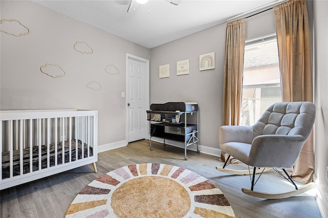 bedroom with baseboards and wood finished floors