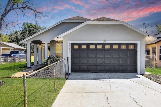 1613 N Lakewood Ave, Ocoee, FL 34761 - view of front of property with concrete driveway, fence, a garage, and stucco siding