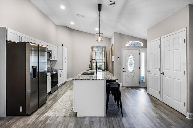 1613 N Lakewood Ave, Ocoee, FL 34761 - kitchen featuring stainless steel appliances, white cabinets, a sink, and light stone counters