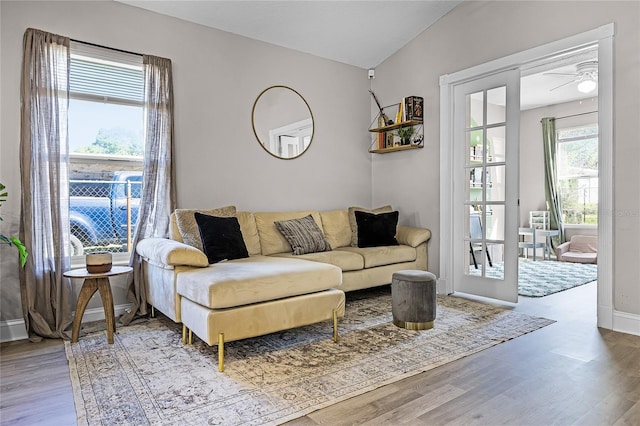 1613 N Lakewood Ave, Ocoee, FL 34761 - living room featuring vaulted ceiling, baseboards, a ceiling fan, and wood finished floors