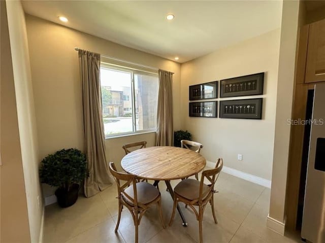 dining area with recessed lighting, baseboards, and light tile patterned floors