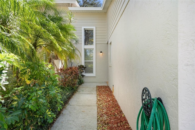 entrance to property featuring stucco siding