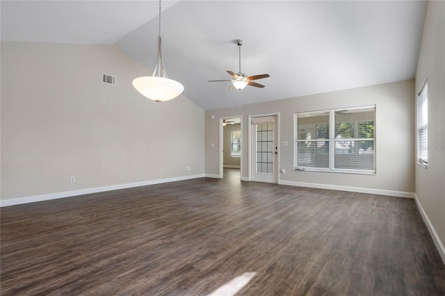 unfurnished living room featuring a healthy amount of sunlight, ceiling fan, visible vents, and dark wood finished floors