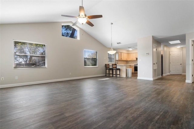 unfurnished living room featuring ceiling fan, dark wood-type flooring, visible vents, and baseboards