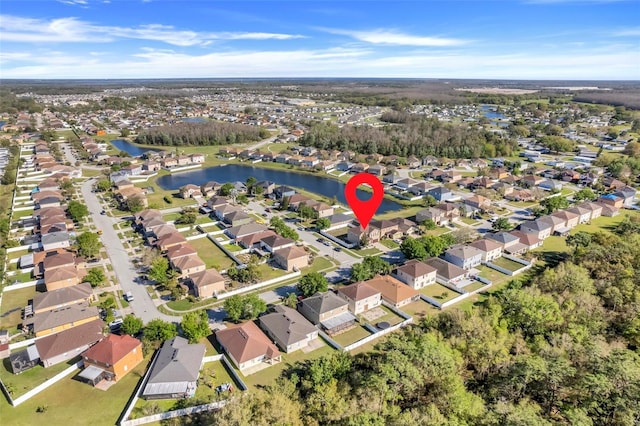 drone / aerial view featuring a residential view and a water view