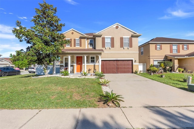 traditional-style house with a garage, covered porch, concrete driveway, stucco siding, and a front lawn