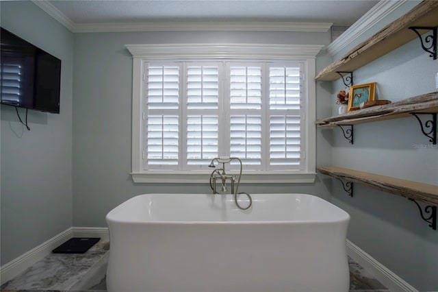 full bath with a freestanding tub, baseboards, and ornamental molding