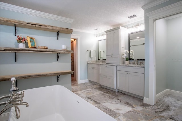 bathroom with vanity, visible vents, a freestanding tub, a textured ceiling, and marble finish floor