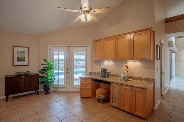 kitchen featuring light tile patterned floors, french doors, a ceiling fan, and light stone countertops