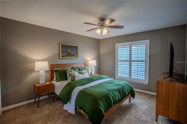 carpeted bedroom with a ceiling fan and baseboards