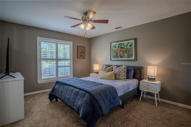 carpeted bedroom with baseboards, visible vents, and ceiling fan