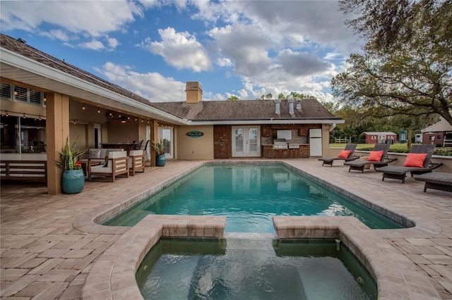 view of pool with a patio, area for grilling, an outdoor living space, and a pool with connected hot tub