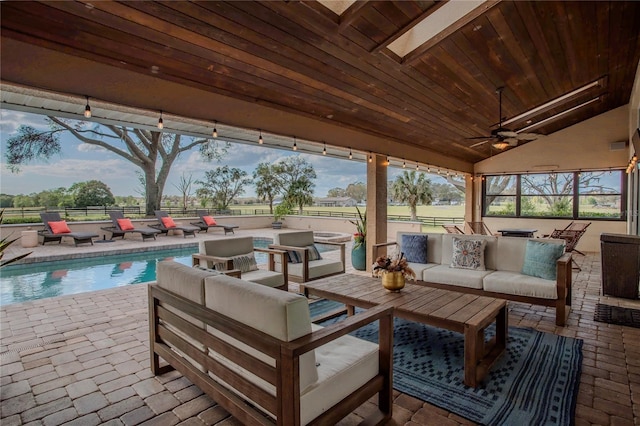 view of patio / terrace featuring outdoor lounge area, fence, a fenced in pool, and ceiling fan