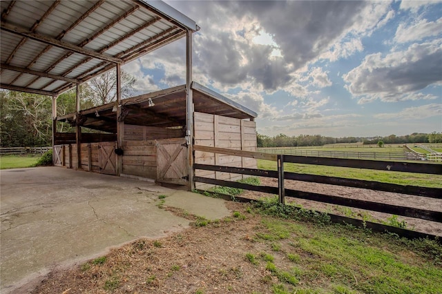 view of stable with a rural view