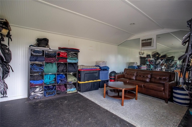 living area featuring lofted ceiling and a wall mounted AC