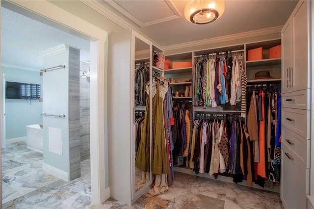 walk in closet featuring marble finish floor