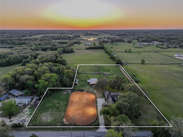 birds eye view of property with a rural view