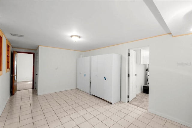 unfurnished room featuring visible vents, baseboards, and light tile patterned flooring