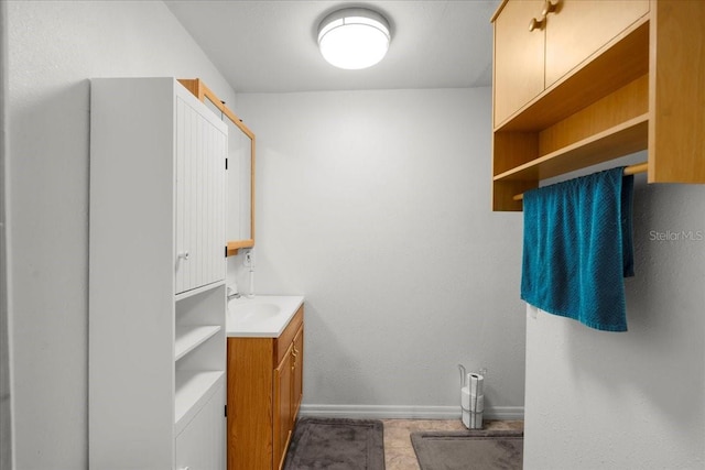 bathroom featuring baseboards and vanity