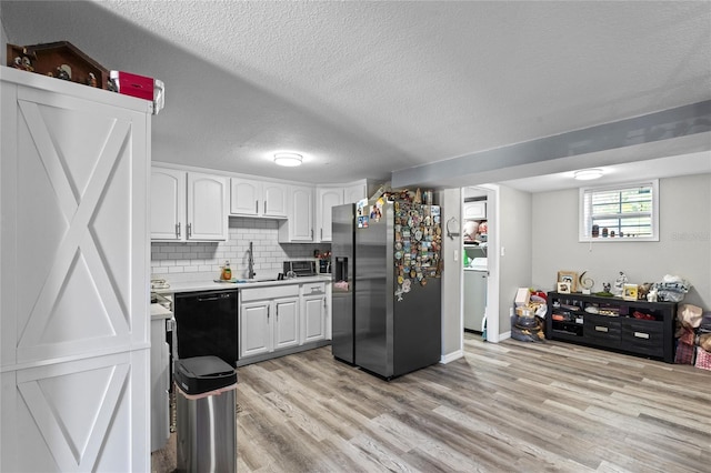 kitchen with dishwasher, stainless steel fridge with ice dispenser, light countertops, light wood-style floors, and a sink