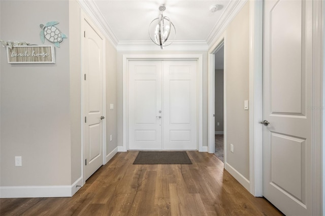 interior space with dark wood-style floors, ornamental molding, and baseboards