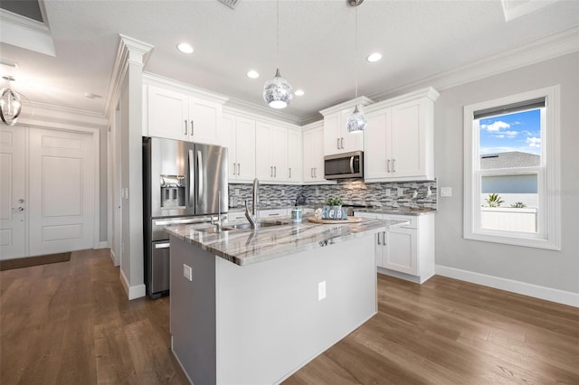 kitchen featuring tasteful backsplash, stainless steel appliances, ornamental molding, and light stone countertops