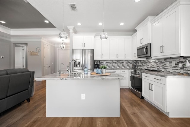 kitchen featuring dark wood-style flooring, visible vents, white cabinetry, appliances with stainless steel finishes, and backsplash