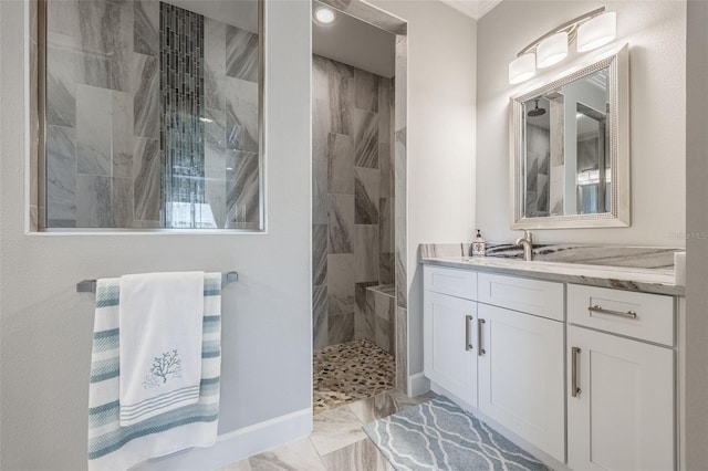 full bath with marble finish floor, walk in shower, and vanity