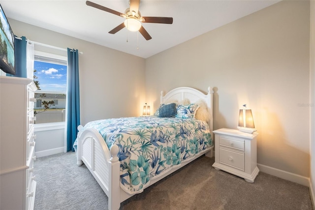 carpeted bedroom with ceiling fan and baseboards