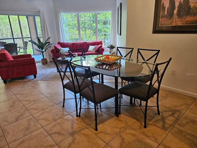 dining area with light tile patterned floors and baseboards