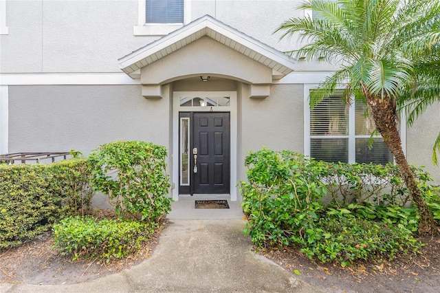 entrance to property with stucco siding