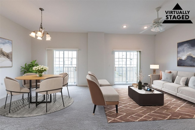 living room with ceiling fan with notable chandelier, recessed lighting, a healthy amount of sunlight, and carpet floors