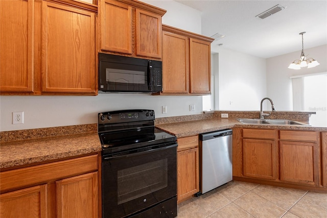 kitchen with visible vents, black appliances, a sink, brown cabinetry, and light tile patterned floors