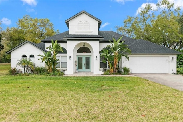 view of front of house featuring french doors, stucco siding, concrete driveway, an attached garage, and a front lawn