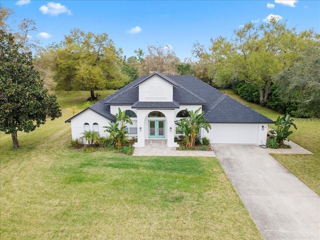 view of front facade featuring a garage, concrete driveway, and a front lawn