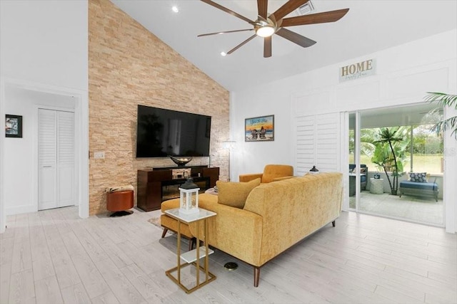 living area with high vaulted ceiling, a ceiling fan, recessed lighting, and wood finished floors