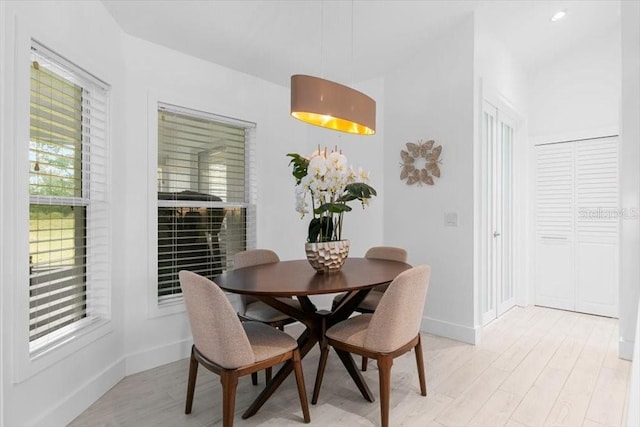 dining room with light wood-style floors and baseboards