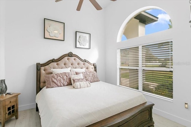 bedroom featuring ceiling fan, wood finished floors, and baseboards