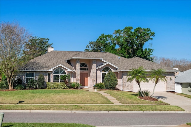 ranch-style home featuring brick siding, concrete driveway, a front yard, a chimney, and an attached garage