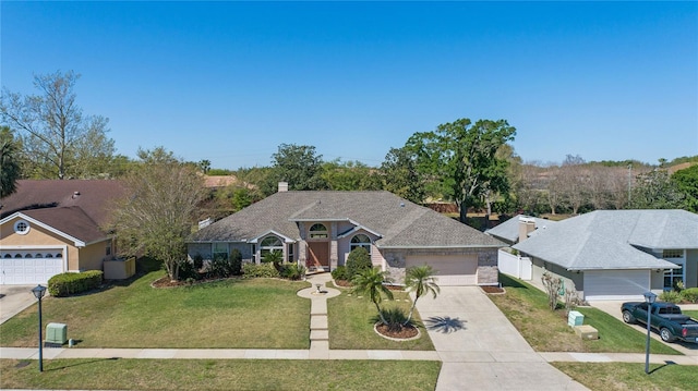 ranch-style house featuring an attached garage, concrete driveway, and a front yard