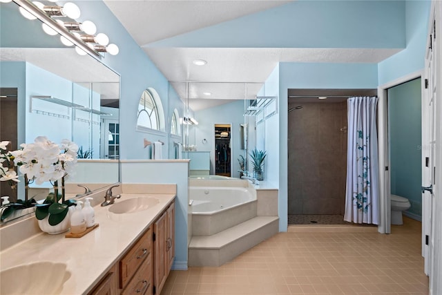 bathroom with lofted ceiling, double vanity, a whirlpool tub, a stall shower, and a sink